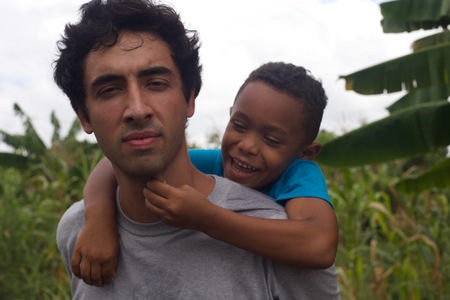 Helper with neighborhood child, Oasis Church, Santiago De Los Caballeros, Dominican Republic 